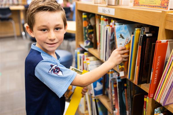 Student with books inside the library